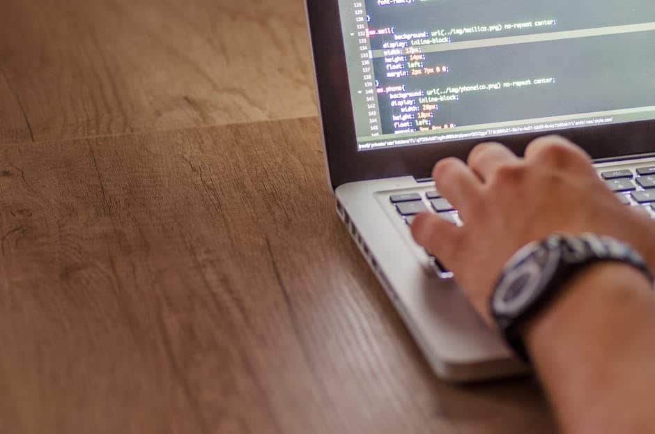 web performance optimization - Close-up of a person coding on a laptop, showcasing web development and programming concepts.