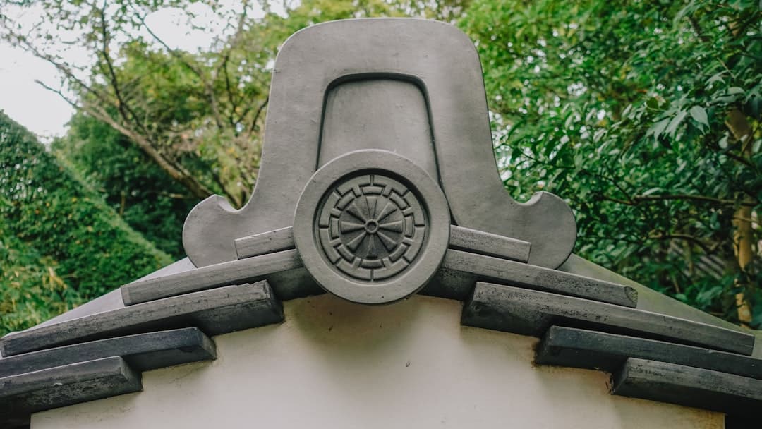AI-powered cybersecurity - Close-up of ornate japanese roof tile with circular emblem.