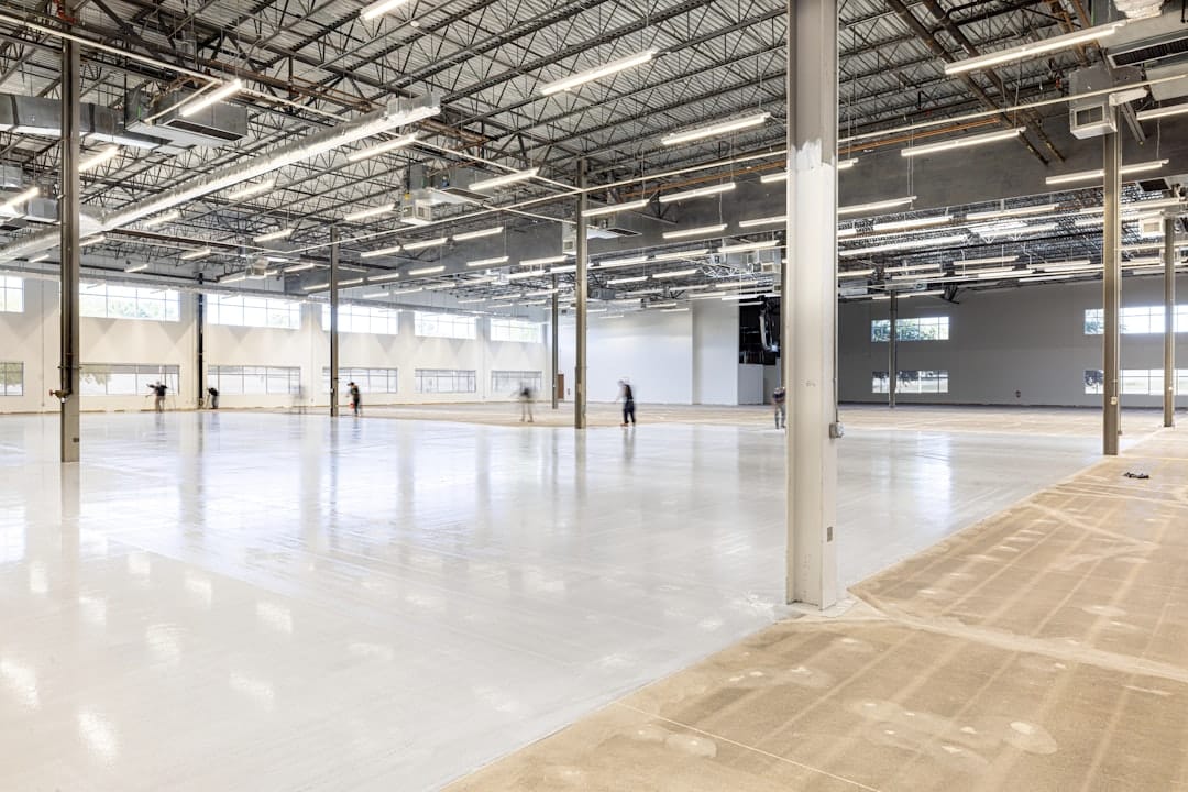 edge computing - Empty, modern warehouse interior with polished concrete floor.