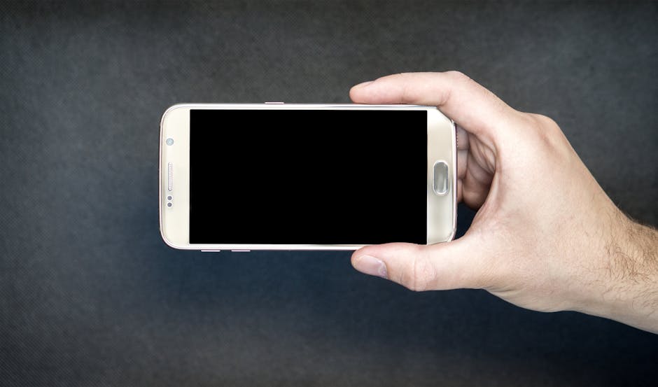 WCAG compliance - Close-up of a hand holding a smartphone with a blank screen, ready for design mockup.