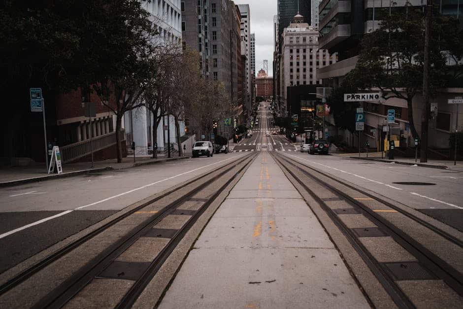 City street view with railway tracks and tall buildings, capturing downtown atmosphere.