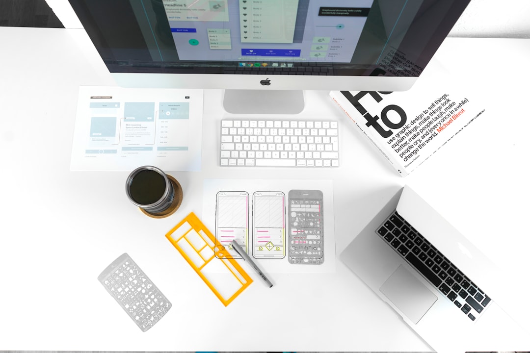 web development news May 2026 - silver MacBook Air on table near iMac
