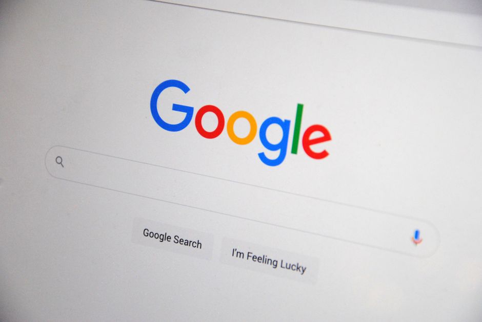 web development news - Close-up of the Google homepage on a screen showing search options.