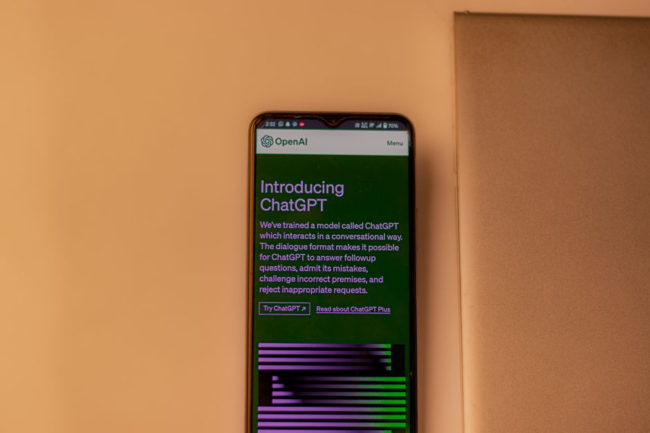 consumer tech - A smartphone showing the ChatGPT interface, emphasizing technology and AI indoors.